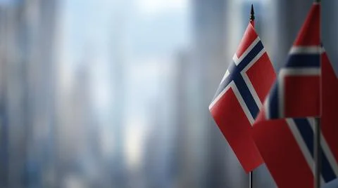 Small flags of the Norway on an abstract blurry background Stock Illustration