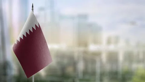 Small flags of the Qatar on an abstract blurry background Stock Illustration