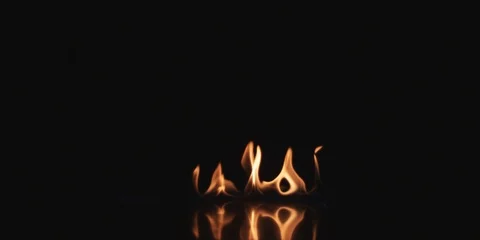 Small flame on black surface Stock Footage 102127394