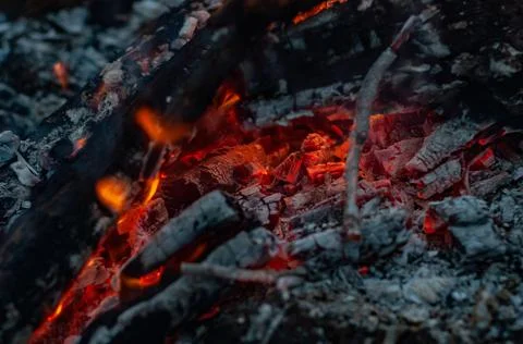 Small flame dying fire, bright red-orange flame. Cozy warm atmosphere by outd Stock Photos