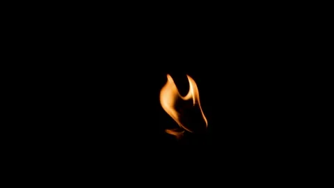 Small Flame Flickering Softly in Dark Environment Representing Eternal Ligh.. Stock Footage 344720517