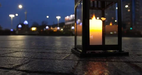 Small flame moving in a candle on a busy street at night time. Time-lapse Stock Footage 150528083