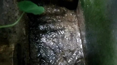 Small flow of water in concrete drains Stock Footage 201239581
