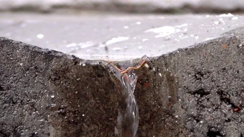 Small flow of water through a concrete gutter Stock Footage 148101699