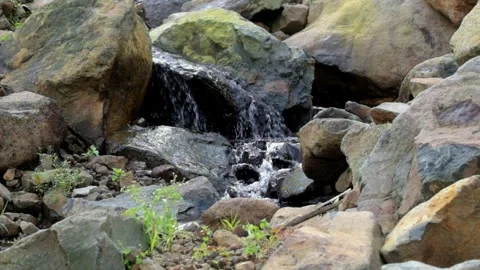 Small flowing water on mountain rocks Video stock 280378594