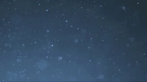 The small flying particles in emptiness. Stock Footage 100799305