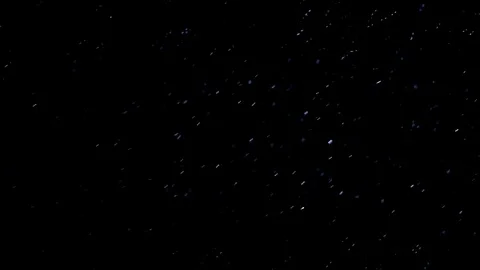 The small flying particles in emptiness. Stock Footage 100799313