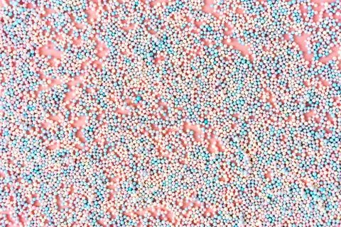 Small foam balls on pink pastel background and the inscription Xmas Stock Photos