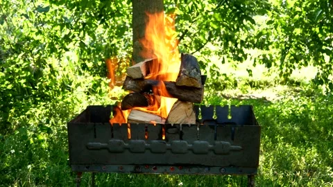 A small folding portable brazier filled with burning wood. Stock Footage 206128760