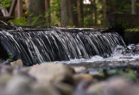 Small forest waterfall with clear water Stock Photos