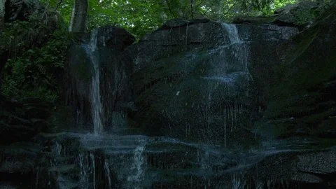 Small forest waterfall, close-up, panning down, 4K Stock Footage 92648253