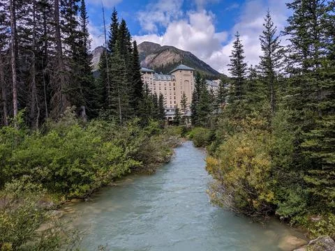 A Small Forested Stream Flows from the Fairmont Chateau Lake Louise Hotel Stock Photos