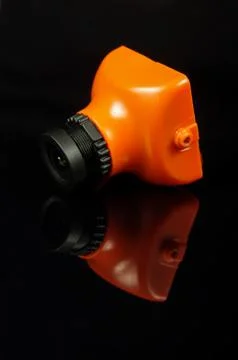 Small FPV drone camera isolated on the black background Foto stock