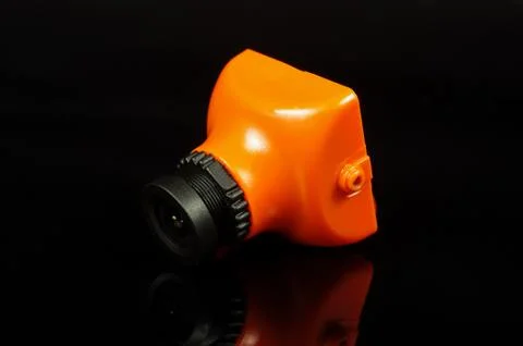 Small FPV drone camera isolated on the black background Stock Photos