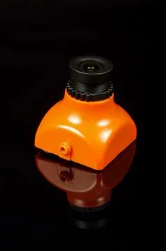 Small FPV drone camera isolated on the black background Stock Photos