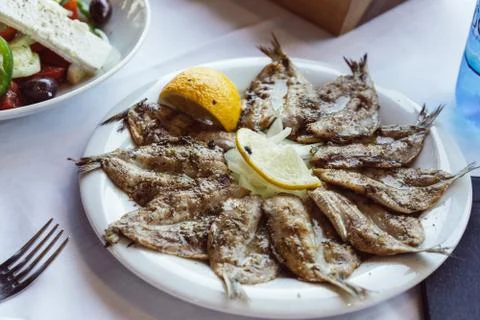 Small fried fish appetizer served with lemon Stock Photos