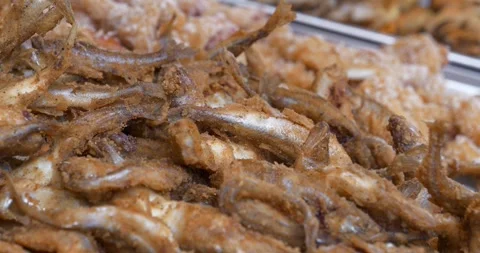 Small fried fish in batter. Tiny battered and fried fish Video stock 277348874