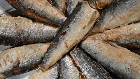 Small Fried Fish Spinning on Plate. Top-Down Seamless Loop of Crispy Fish Stock Footage 325424740