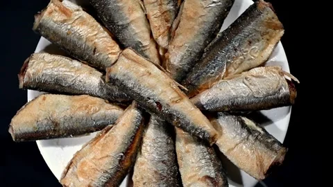 Small Fried Fish Spinning on Plate. Top-Down Seamless Loop of Crispy Whole Fish Stock Footage 325811537
