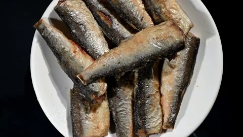 Small Fried Fish Spinning on Plate. Top-Down Seamless Loop of Crispy Whole Fish Stock Footage 325966905