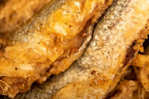 Small fried fish, surface texture, background image, close-up, selective focu Stock Photos