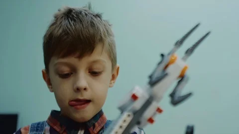 Small funny child is learning to control hand of robot in school, close-up Stock-Footage 92948468