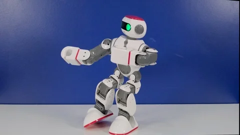 Small funny robot toy moves hands changing pose Stock Footage 116281542