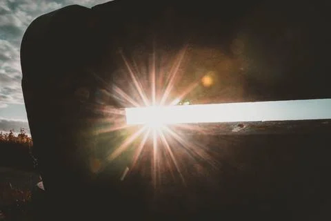 A small gap allows a beam of bright sunlight to stream through Stock Photos