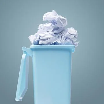 Small garbage can full of paper Stock Photos