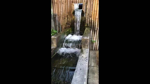 Small Garden Artificial Waterfall Cascading in Daylight Video stock 343589001