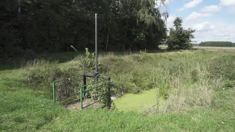 A small gateway on the ameliorative channel in the field. Stock Footage 152337406