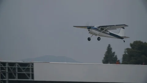 Small generic private propeller airplane flying against cloudy sky Stock Footage 115239819