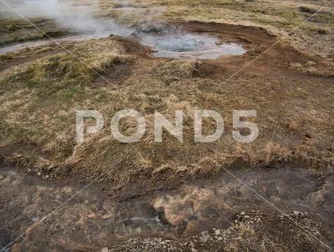 A small geothermal pool with boiling water Stock Photos