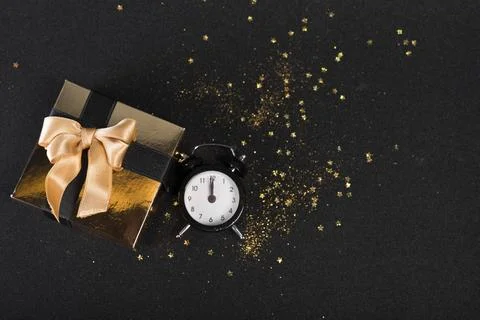 Small gift box with clock black table 스톡 사진