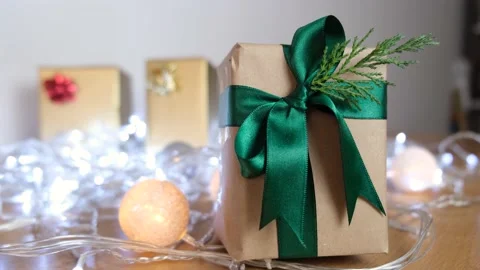 Small gift box with green ribbons and effect led lights on the back decorated wi Vídeo Stock 142060461