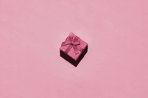 Small gift box lie on texture background of fashion trendy paper in minimal.. Stock Photos