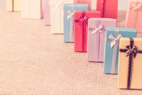 Small gift box set on sack cloth Stock Photos