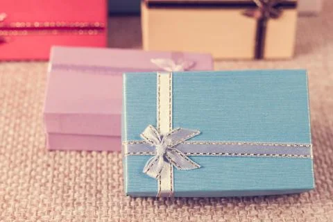 Small gift box set on sack cloth Stock Photos