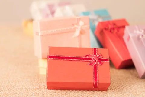 Small gift box set on sack cloth Stock Photos