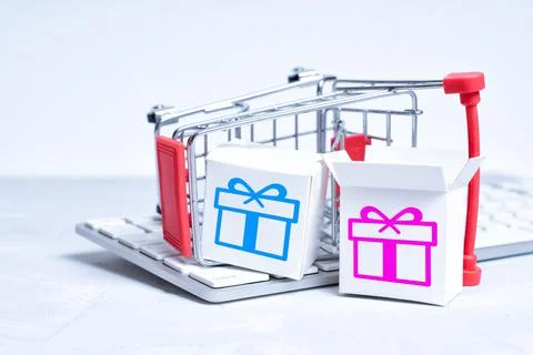 Small gift boxes placed on keyboard by a push cart 스톡 사진