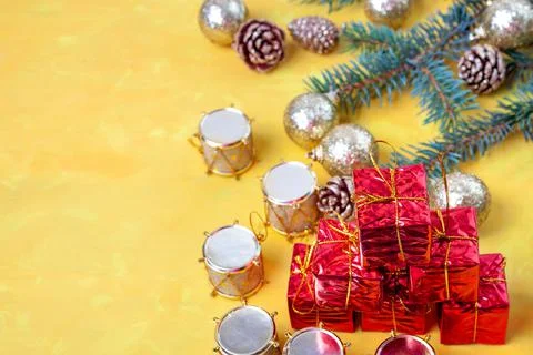 Small gift boxes in a stack on the table, drums and golden balls Stock Photos