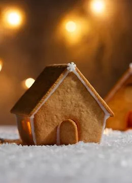 Small gingerbread house without decorations against a background of blurred Stock Photos