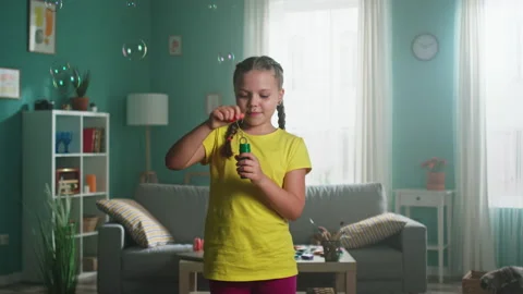 Small Girl Is Blowing Bubbles 스톡 동영상 147353754
