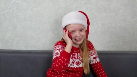 Small girl in Christmas hat talking to phone. Congratulations Stock Footage 142423053