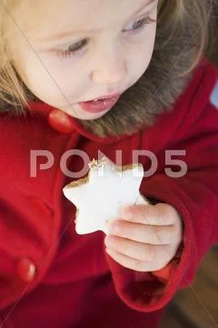 Small Girl Eating Cinnamon Star