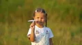 The small girl hold and launch paper airplane. Slow motion capture HD Footage