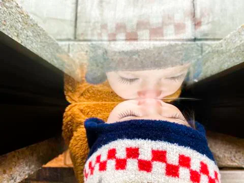 Small Girl Looking Through Window Stock Photos