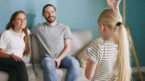 Small Girl Is Playing Interactive Game with Parents Stock Footage 144402220