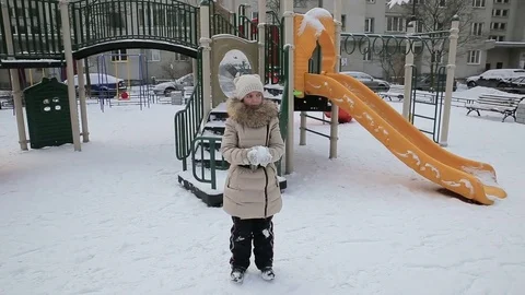 Small girl playing in the snow Stock Footage 73356355