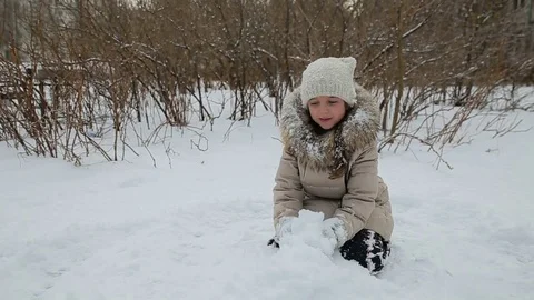 Small girl playing in the snow Stock Footage 73357104